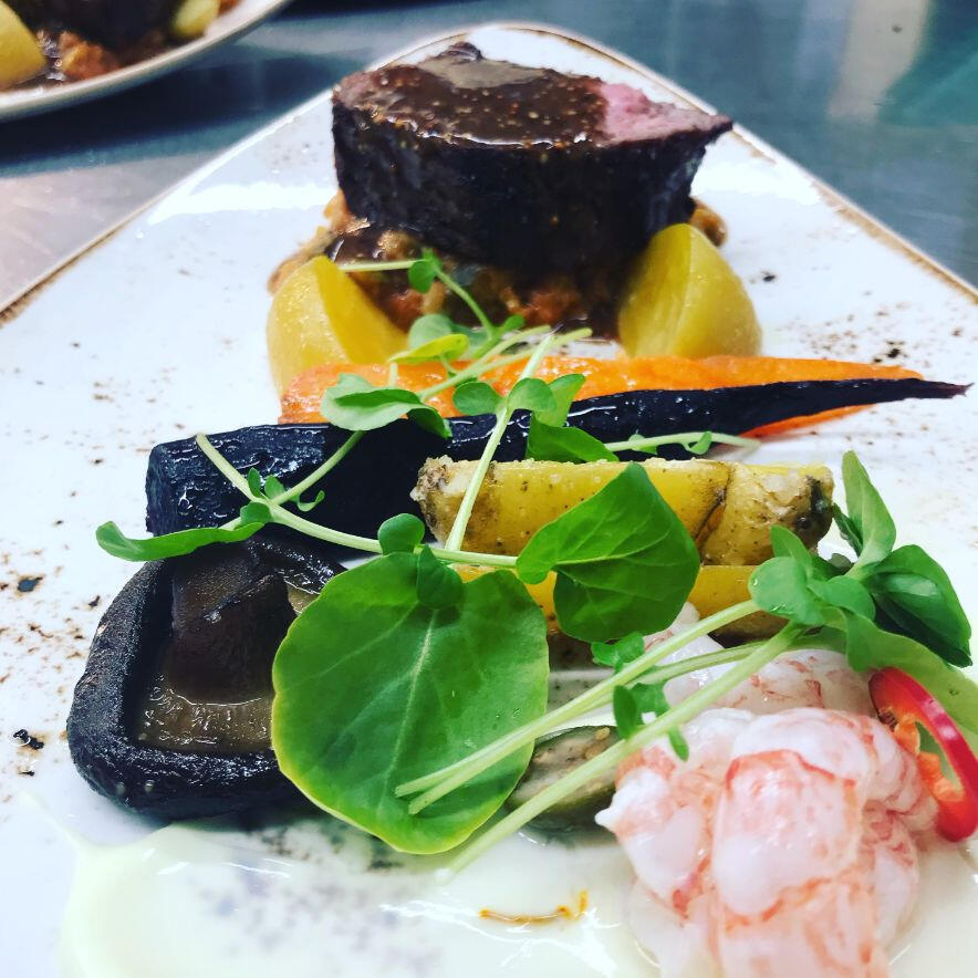 A beautifully arranged plate containing meat, vibrant vegetables, and a flavorful sauce, showcasing a delightful meal. A beautifully arranged plate containing meat, vibrant vegetables, and a flavorful sauce, showcasing a delightful meal.
