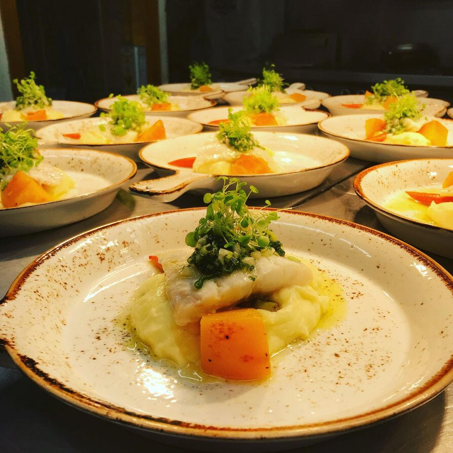 A large assortment of plates filled with various types of food arranged neatly on a table. A large assortment of plates filled with various types of food arranged neatly on a table.